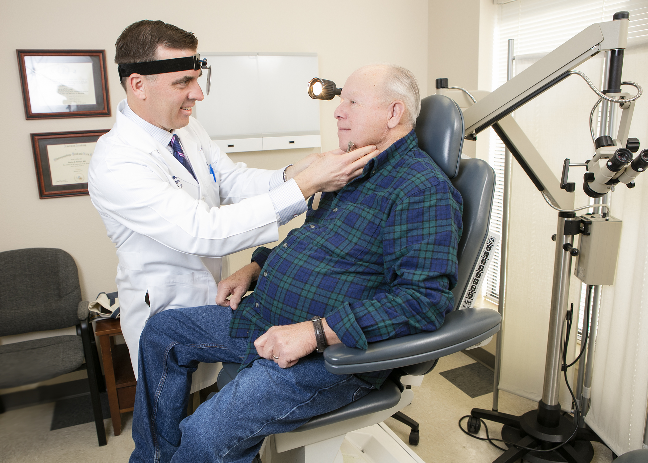 Doctor Examines Patient Thyroid